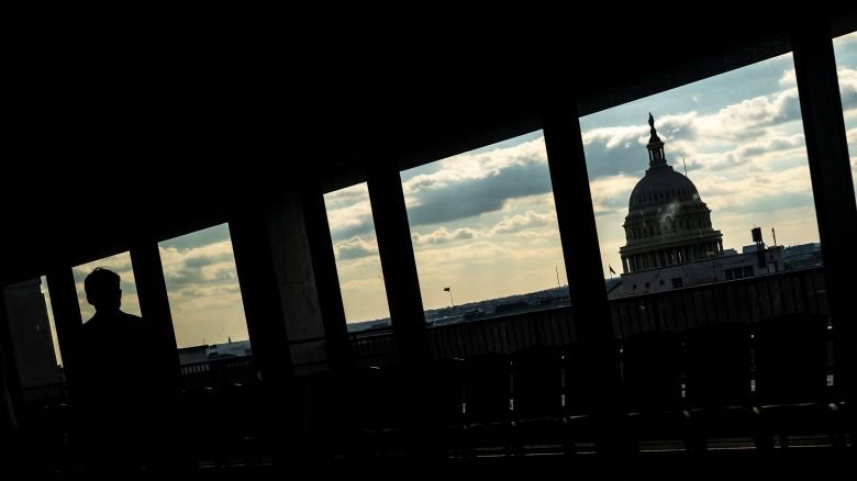 A senate staffer is silhouetted near the US Capitol in Washington, DC, on Thursday.