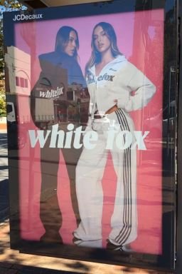 In an image submitted by Adidas in its legal filing, a model wearing White Fox four-stripe shorts poses next to an advertisement for White Fox clothing.
