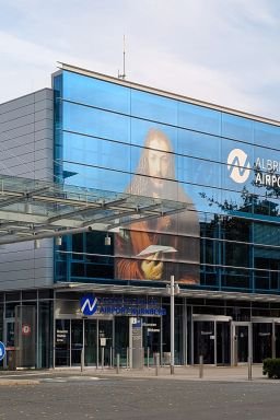 The glass facade at Albrecht Duerer Airport in Nuremberg, Germany, on October 19, 2025, features a large depiction of Albrecht Duerer's self-portrait holding a paper airplane.