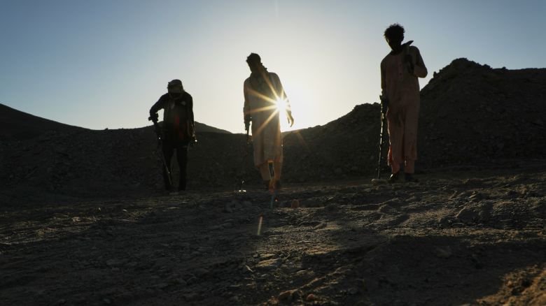 Miners use metal detectors to search for gold at an artisanal mining site in Dalago Mahas, northern Sudan, on May 7, 2026.