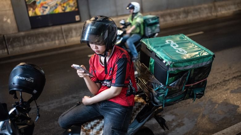 A Grab motorcycle delivery driver in central Bangkok, Thailand, on August 18, 2026.