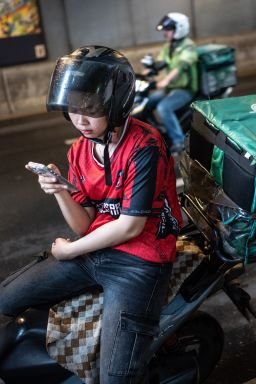 A Grab motorcycle delivery driver in central Bangkok, Thailand, on August 18, 2026.