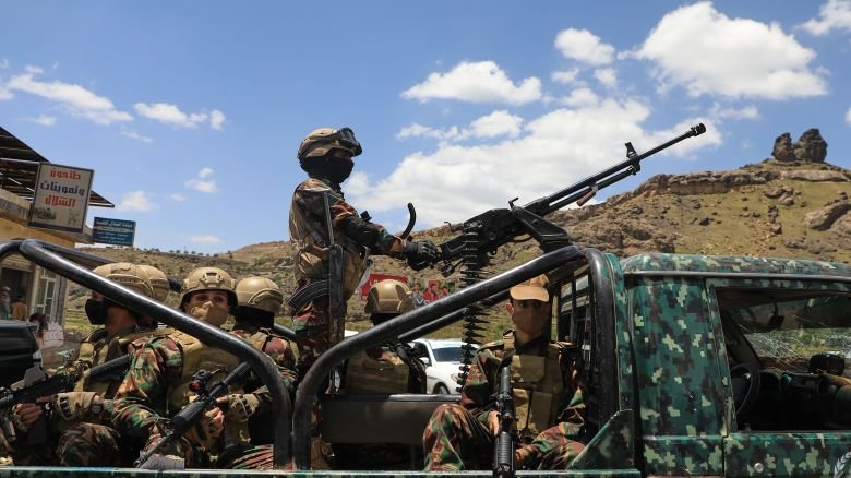 Houthi fighters escort a convoy carrying prisoners freed in Mokha through the Bani Matar district on its way to Sanaa, Yemen, on Saturday, September 12, 2026,  following the Houthi takeover of the southern Red Sea port city.