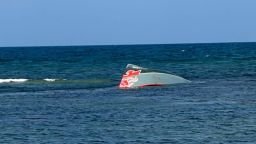 A migrant vessel lies partially submerged after it capsized near Guhere, north of Obock, Djibouti, while carrying 305 passengers, on Saturday, Oct. 10.