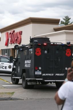 FILE - A crowd gathers as police investigate after a shooting at a supermarket on May 14, 2022, in Buffalo, N.Y. (AP Photo/Joshua Bessex, File)