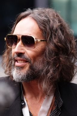 British comedian Russell Brand speaks to the media as he arrives at Southwark Crown Court in London on Wednesday.
