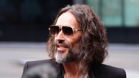British comedian Russell Brand speaks to the media as he arrives at Southwark Crown Court in London on Wednesday.