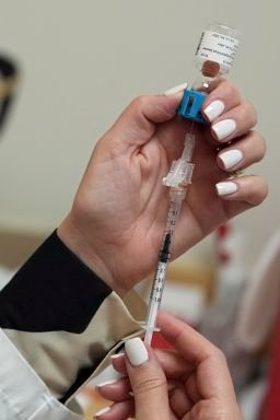 Pharmacy manager Aylen Amestoy draws a dose of respiratory syncytial virus (RSV) vaccine into a syringe as she prepares a shot for a patient at a CVS Pharmacy in Miami, in 2025.