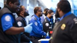 Transportation Security Administration agents sit as they check boarding passes and IDs at Ronald Reagan Washington National Airport, on Monday, January 26, 2026.