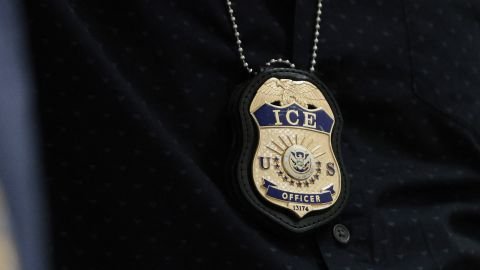 The badges of Immigration and Customs Enforcement agents are seen as they patrol the halls of an immigration court in New York in May.