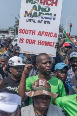 Protestors from the anti-illegal immigration group, March and March Movement hold placards and chant slogans during a demonstration in Durban, on September 10.