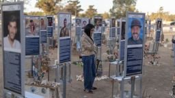 An Israeli woman pays her respects at the memorial to the victims of the 2023 Hamas attacks at the Nova festival site in Reim, southern Israel, on October 6, 2026. Israel's defence minister on October 6 said he had put the military on high alert before the anniversary of Hamas's October 7, 2023 attack, warning Gazans would pay a "heavy price" if forces were harmed.