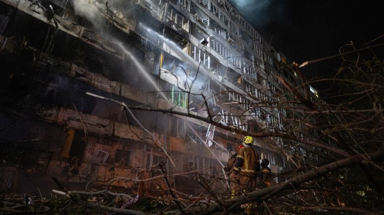 Ukrainian firefighters extinguish a blaze at the site of a Russian missile strike at an apartment building in Kyiv on Wednesday.