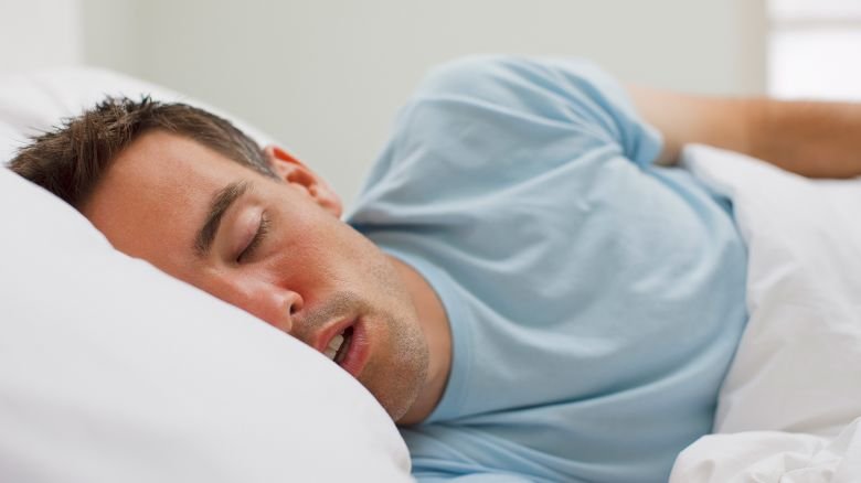 Sick man sleeping in bed
