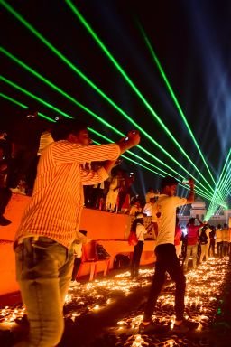 People watch a laser show on the banks of the river Sarayu during Deepotsav celebrations on the eve of the Hindu festival of Diwali in Ayodhya on November 3, 2021. (Photo by SANJAY KANOJIA / AFP) (Photo by SANJAY KANOJIA/AFP via Getty Images)