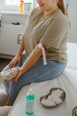 Doctor talking to smiling patient while doing medical exam in clinic