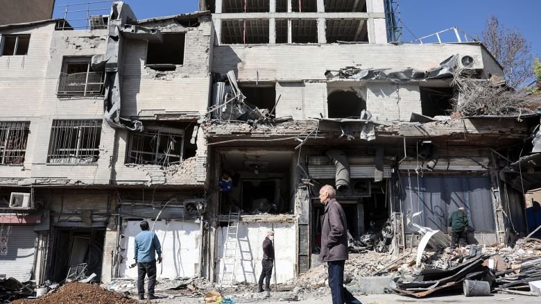 A man walks past a destroyed building following airstrikes in central Tehran, Iran, on March 4, 2026.