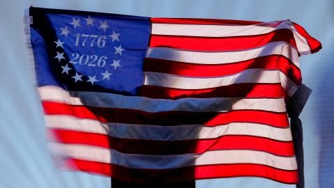 A spectator holds a US flag on the National Mall, during the UFC Freedom250 fight on the South Lawn of the White House, on June 14.