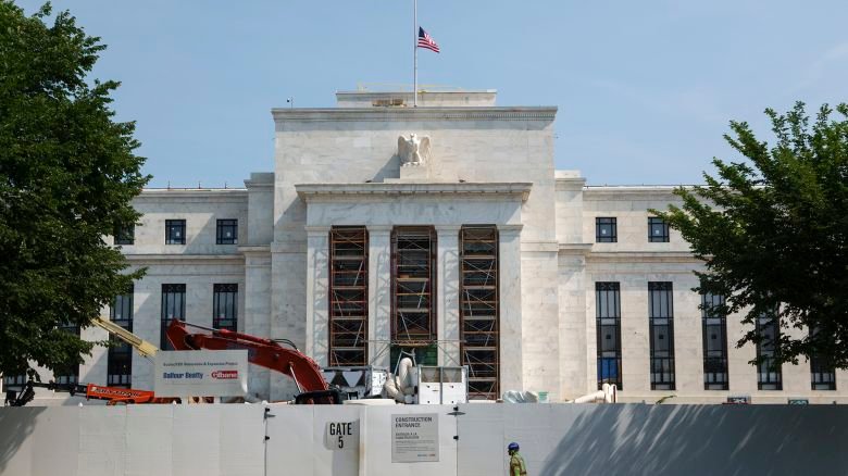 A construction worker walks by the Federal Reserve Building in Washington, DC, on July 15.