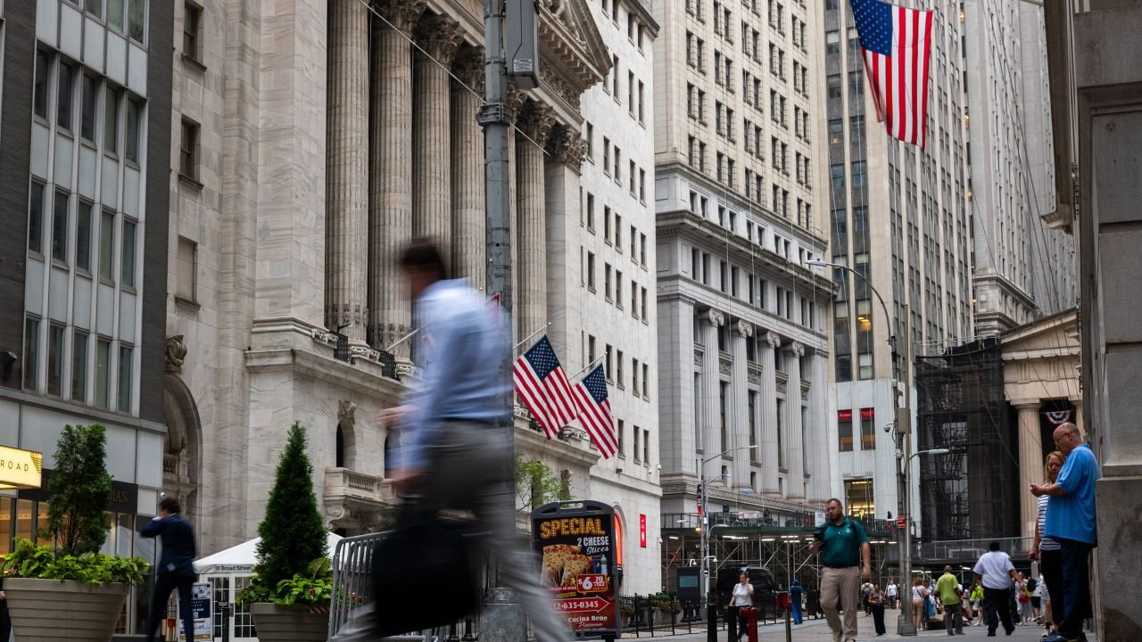 People walk by the New York Stock Exchange on July 21, 2026, in New York.
