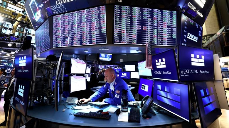 A trader works on the floor of the New York Stock Exchange on August 4, 2026 at the opening bell. The Dow on Tuesday closed above 54,000 points for the first time.