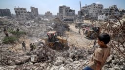A child observes emergency crews among the rubble in Gaza City, northern Gaza, on September 8. Around 8,000 people are estimated to be missing, most of whom are likely buried beneath debris after repeated Israeli strikes.