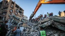 Rescue workers extract bodies from the rubble after a previously damaged six-story building collapsed in Gaza City on Wednesday.
