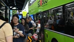People alight from a public bus in Singapore on September 21, 2026.
