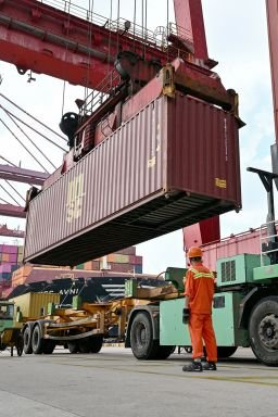 Cranes load containers onto a ship at the Port of Ningbo-Zhoushan in Ningbo, in China's eastern Zhejiang Province on September 22, 2026. (Photo by Hector RETAMAL / AFP via Getty Images)