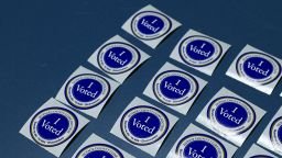 "I Voted" stickers sit on a table at Naperville Municipal Center in Naperville, Illinois, on September 24, 2026, on the first day of early voting ahead of the November 3 midterm elections.