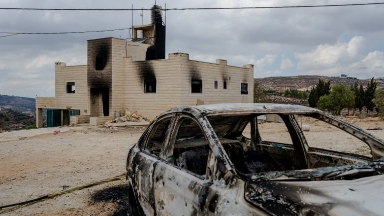 A destroyed car sits outside a burnt house after Israeli settlers attacked the Tubasi family and Israeli security forces who were escorting them back to their home in Jalud. (Photo by Erik Marmor/Getty Images)