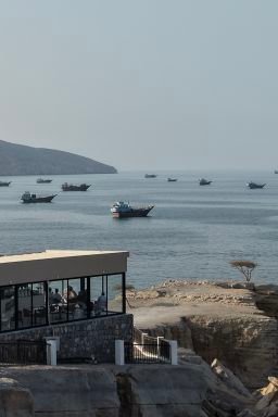 An aerial view shows ships anchored off the coast of Khasab in Oman's Musandam Governorate, near the Strait of Hormuz, on October 2, 2026.
